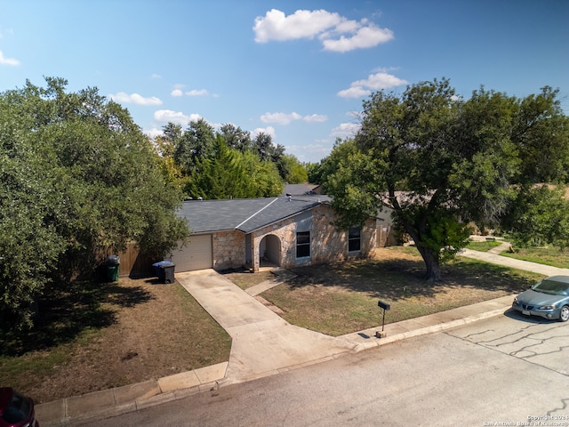 view of front of property with a front yard and a garage