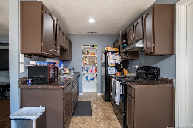 kitchen with black appliances, sink, light tile patterned floors, a textured ceiling, and dark brown cabinetry