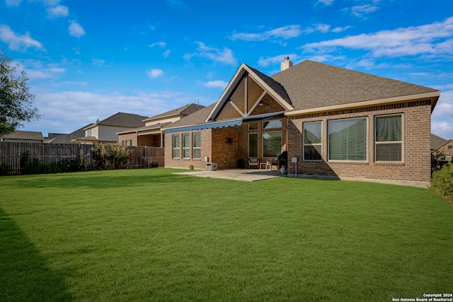 back of house featuring a yard and a patio area