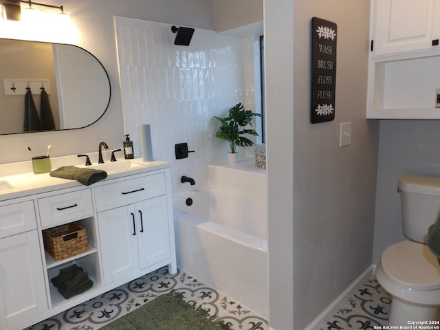 bathroom with tile patterned floors, a bathing tub, vanity, and toilet