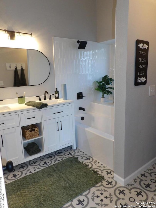 bathroom with tile patterned floors, vanity, and a tub