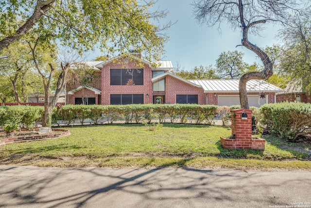 view of front of property with a garage and a front lawn