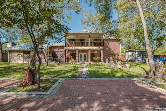 exterior space featuring french doors, central AC, a patio area, and a lawn