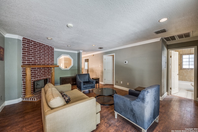 living room featuring a fireplace, a textured ceiling, dark hardwood / wood-style floors, and crown molding