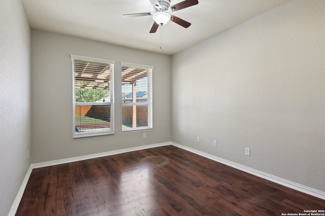 empty room with ceiling fan and dark hardwood / wood-style flooring