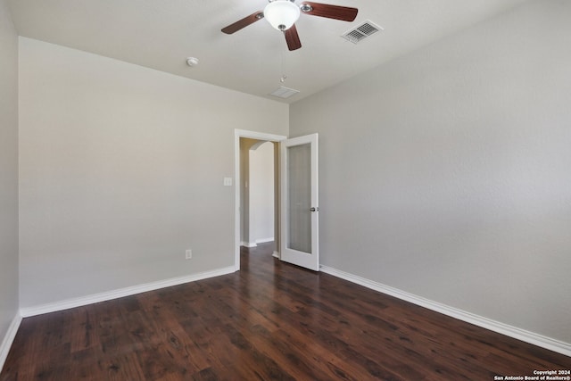 unfurnished room with ceiling fan, french doors, and dark wood-type flooring