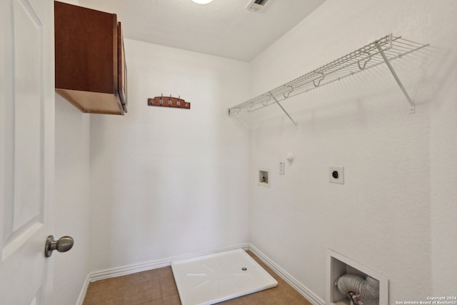 laundry room featuring electric dryer hookup, cabinets, tile patterned floors, hookup for a gas dryer, and hookup for a washing machine