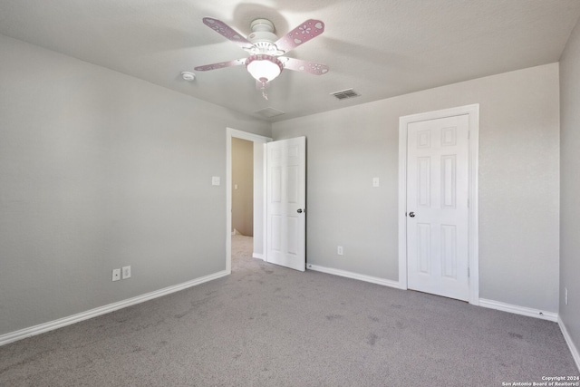 unfurnished bedroom featuring ceiling fan and carpet floors