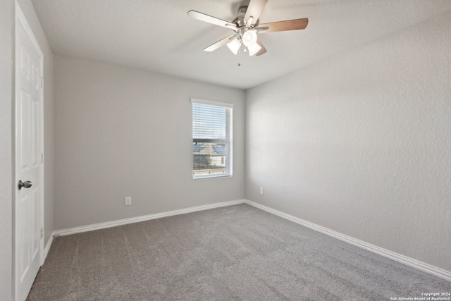 spare room featuring carpet and ceiling fan