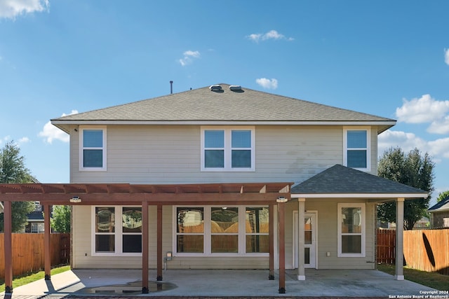 rear view of property with a pergola and a patio area