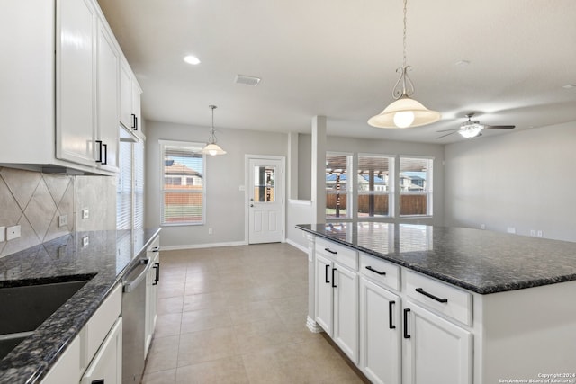 kitchen with a center island, white cabinetry, and hanging light fixtures