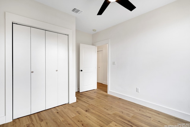 unfurnished bedroom featuring a closet, ceiling fan, and light hardwood / wood-style flooring