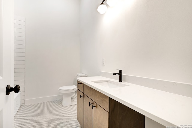 bathroom featuring tile patterned floors, vanity, and toilet