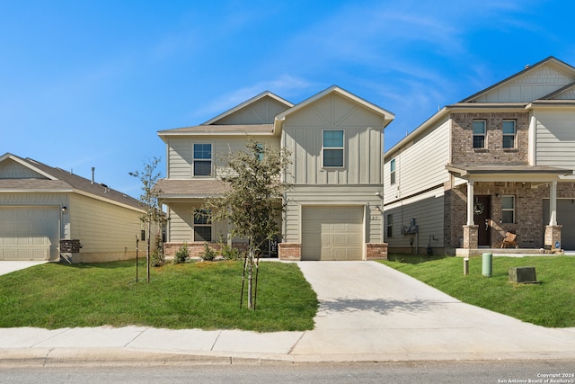 craftsman inspired home with a front yard and a garage