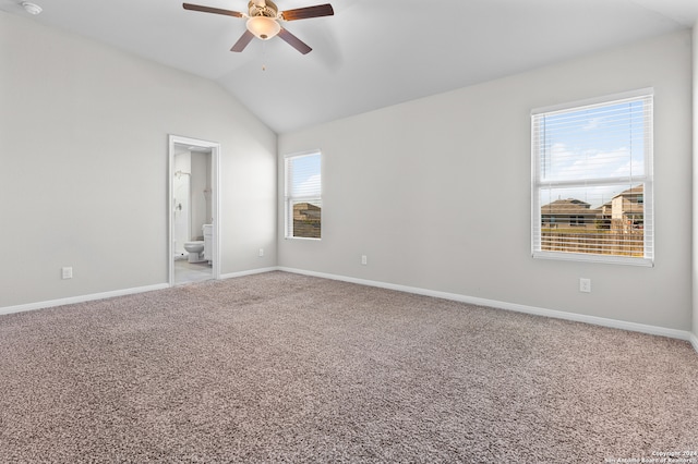 empty room featuring carpet floors, ceiling fan, and lofted ceiling