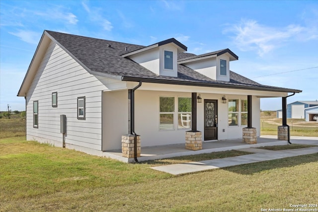 view of front of home with a porch and a front lawn