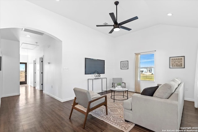 living room featuring vaulted ceiling, ceiling fan, and dark wood-type flooring