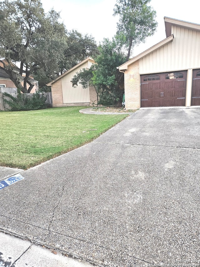 view of property exterior with a lawn and a garage