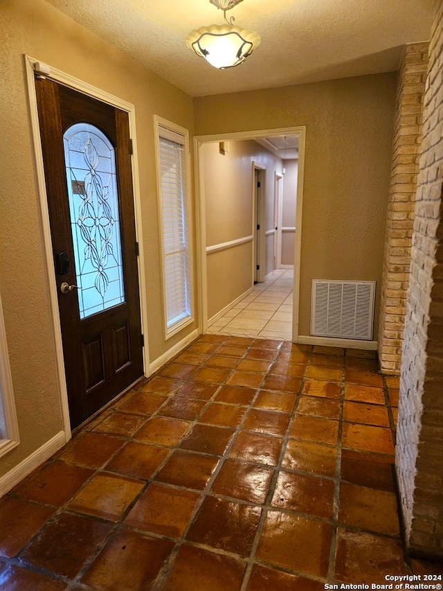 entrance foyer featuring a textured ceiling