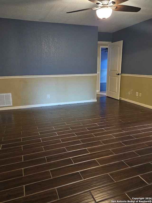 spare room with dark hardwood / wood-style floors and ceiling fan