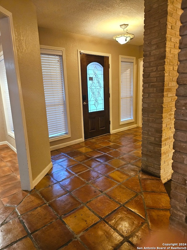 entryway featuring a textured ceiling