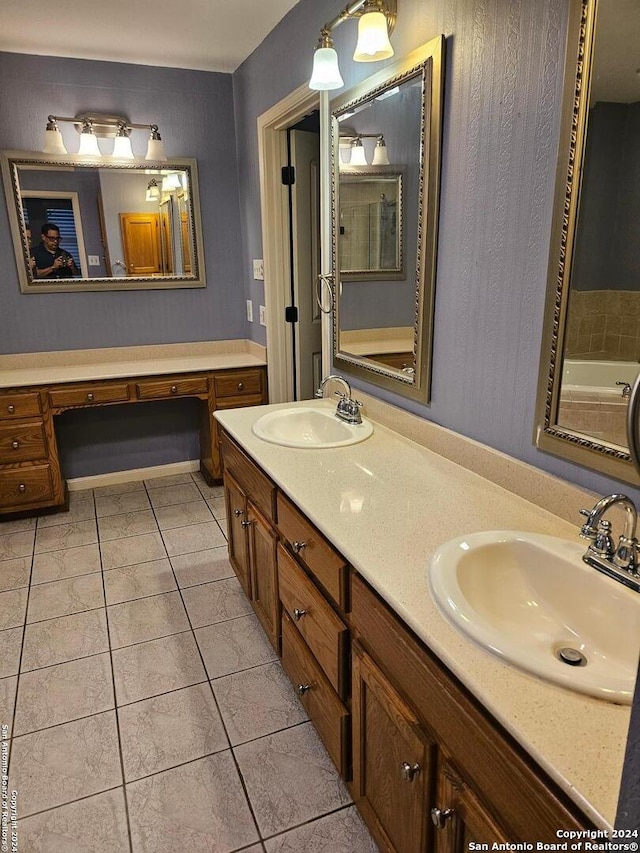 bathroom featuring tile patterned flooring, a bath, and vanity