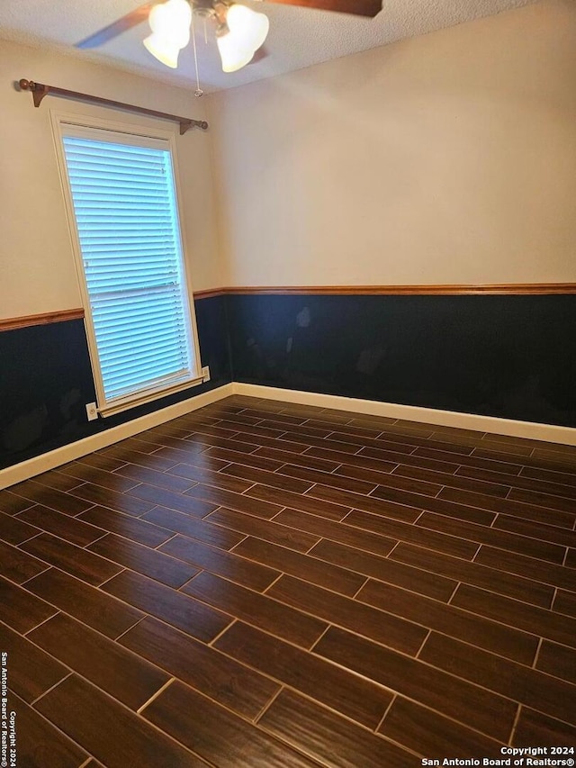 spare room featuring a textured ceiling, dark hardwood / wood-style flooring, and ceiling fan