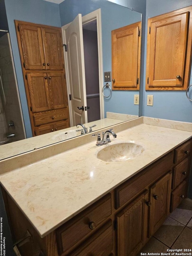 bathroom featuring tile patterned floors, vanity, and a shower