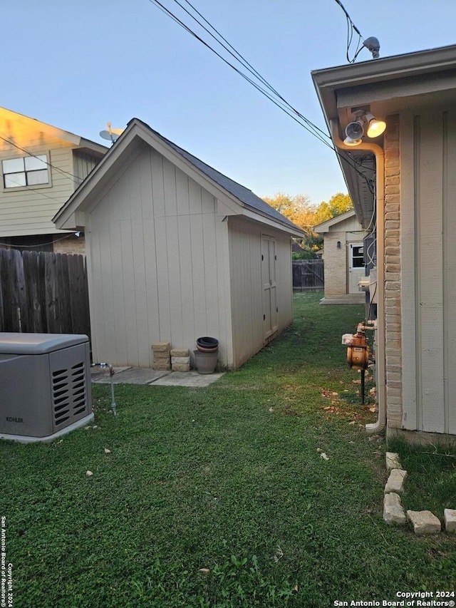 view of side of property featuring a yard and a storage shed