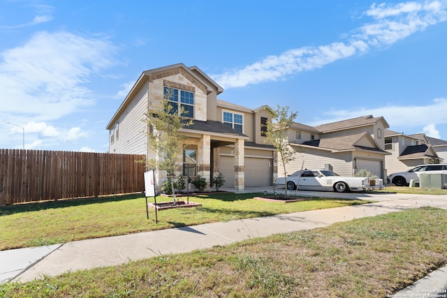 view of front of property featuring a garage and a front lawn