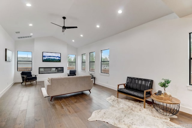 living room featuring hardwood / wood-style flooring, vaulted ceiling, and ceiling fan