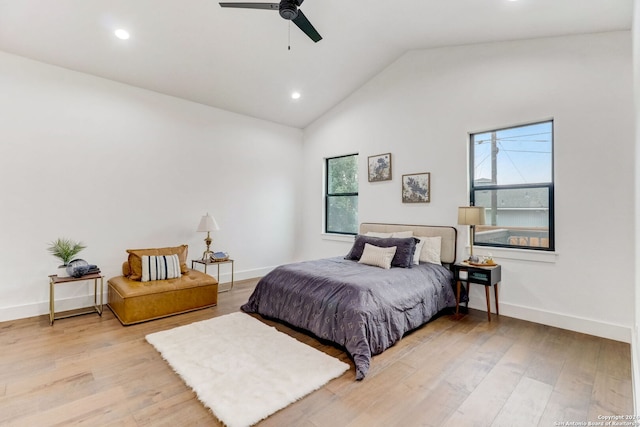 bedroom with ceiling fan, light hardwood / wood-style floors, and vaulted ceiling