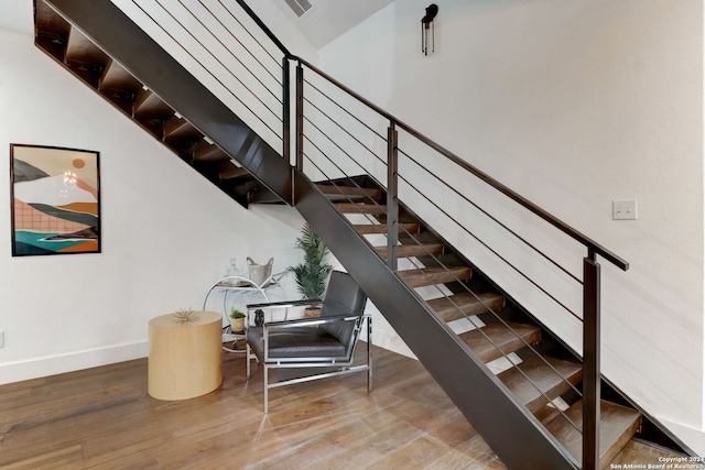 stairs with hardwood / wood-style flooring