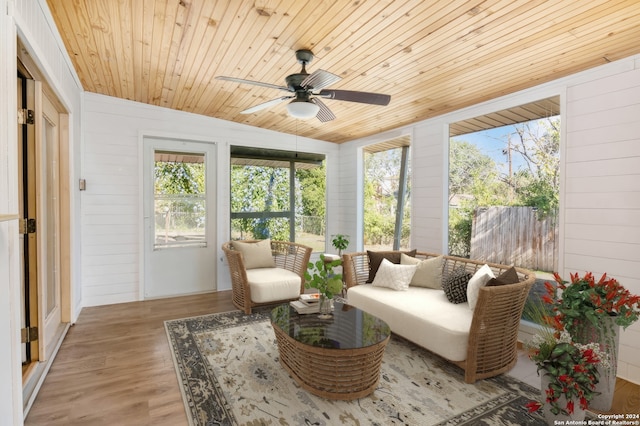 sunroom featuring wooden ceiling, ceiling fan, a healthy amount of sunlight, and vaulted ceiling