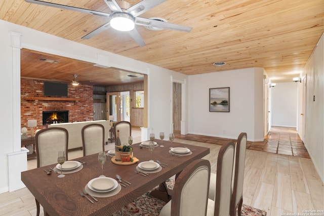 dining space with a fireplace, ceiling fan, light hardwood / wood-style flooring, and wooden ceiling