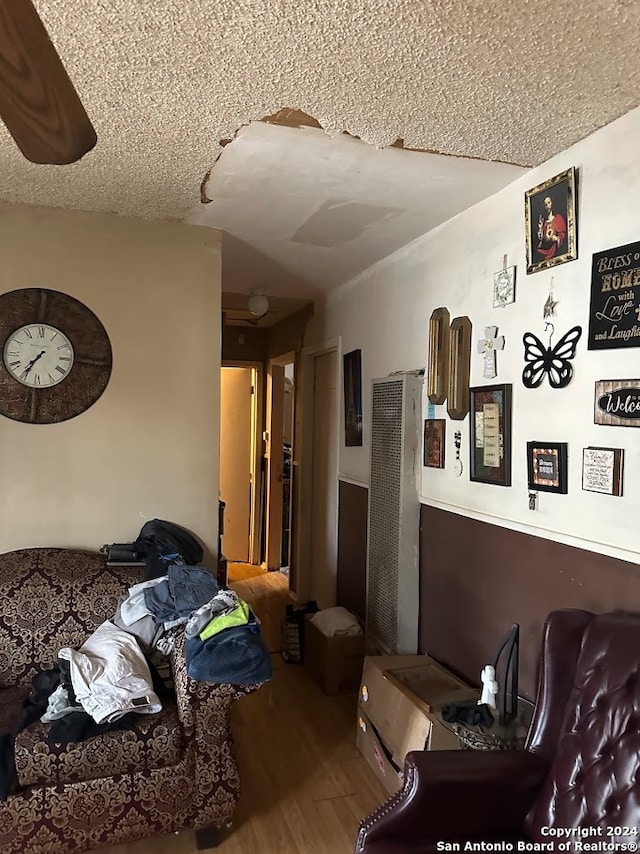 living room featuring hardwood / wood-style flooring and a textured ceiling