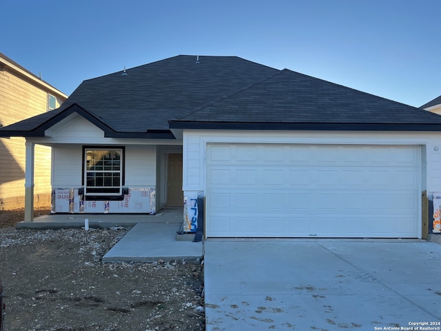 view of front facade with covered porch and a garage