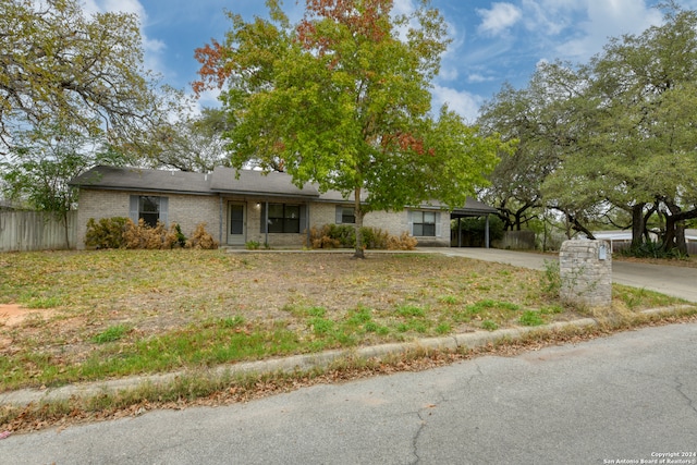 single story home featuring a carport