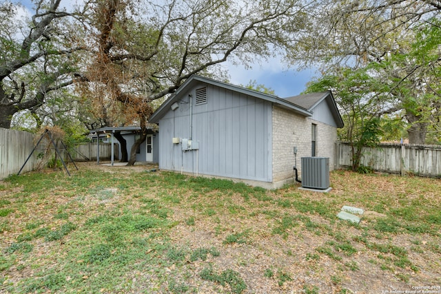 exterior space featuring a lawn and central air condition unit