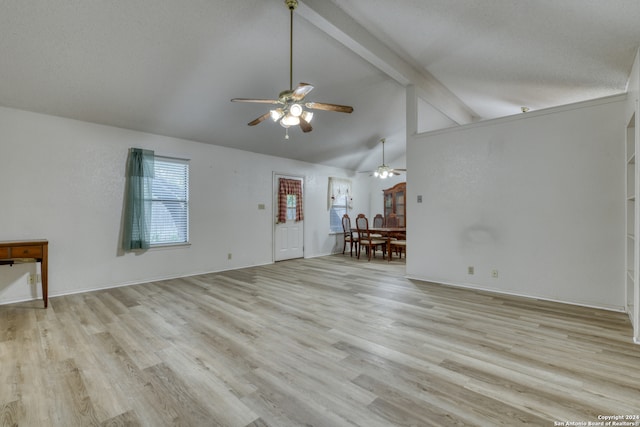 unfurnished living room with light wood-type flooring and vaulted ceiling with beams