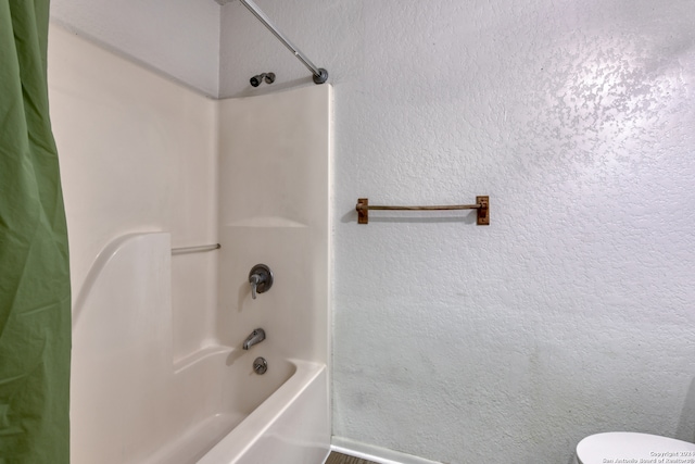 bathroom featuring shower / bath combination with curtain and toilet