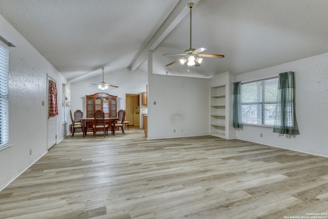 unfurnished living room with vaulted ceiling with beams, ceiling fan, light wood-type flooring, and a textured ceiling