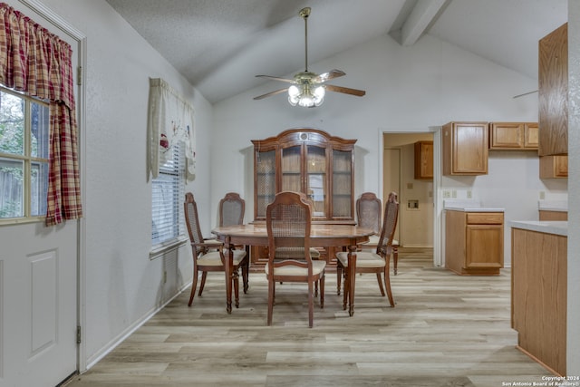 dining space featuring ceiling fan, beam ceiling, high vaulted ceiling, and light hardwood / wood-style flooring