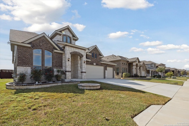 view of front of house with a front yard and a garage