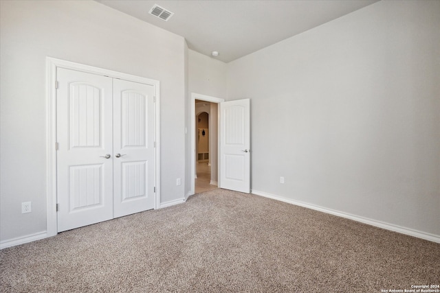 unfurnished bedroom featuring a closet and carpet floors