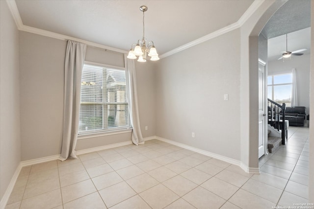 tiled empty room with plenty of natural light, ornamental molding, and ceiling fan with notable chandelier