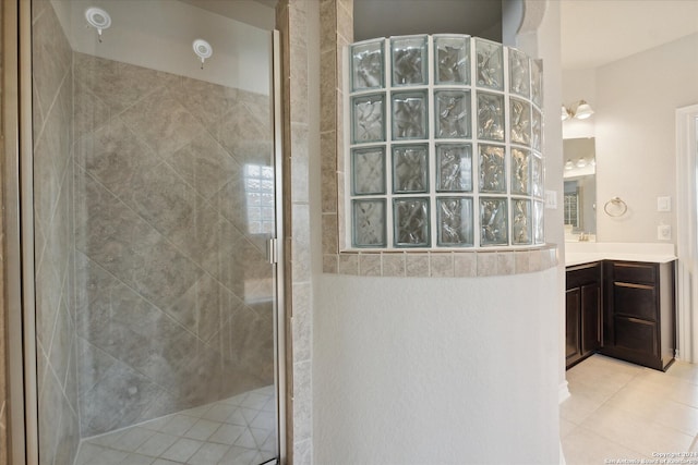 bathroom featuring vanity, tile patterned floors, and a shower with shower door