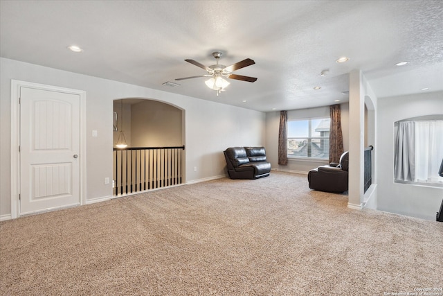 unfurnished room featuring ceiling fan, carpet, and a textured ceiling