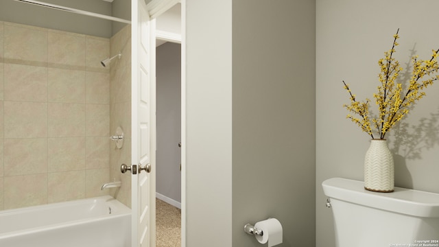 bathroom with tiled shower / bath combo and toilet