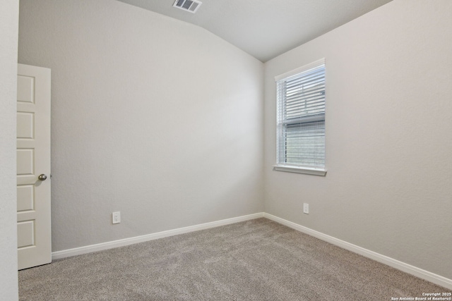 spare room featuring lofted ceiling and carpet floors